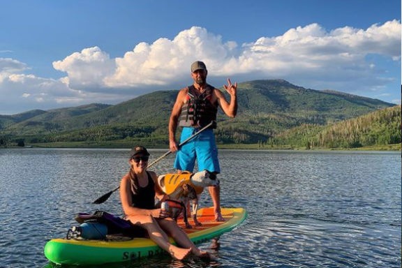 a person riding on the back of a boat in a body of water