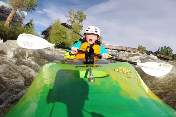 a person riding on the back of a boat in the water